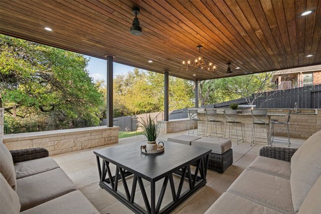 View of patio / terrace with a fenced backyard, an outdoor hangout area, and outdoor dry bar | Image 35
