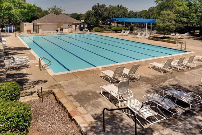 Community pool featuring view of scattered trees and a patio | Image 38