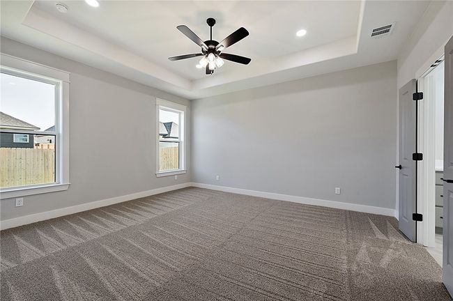 Spare room with a raised ceiling, carpet flooring, baseboards, and recessed lighting | Image 15