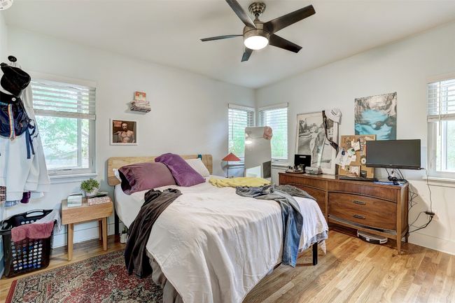 Bedroom with ceiling fan and light wood-style floors | Image 34