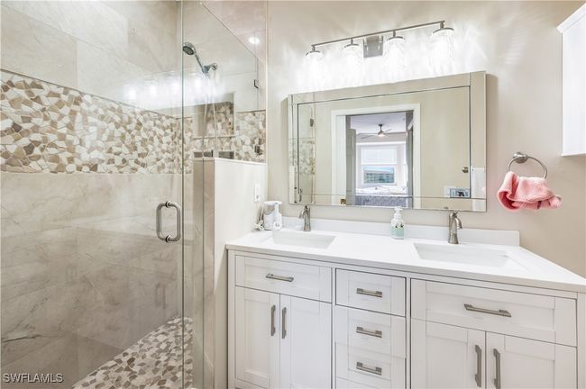 Bathroom with vanity, an enclosed shower, and ceiling fan | Image 15