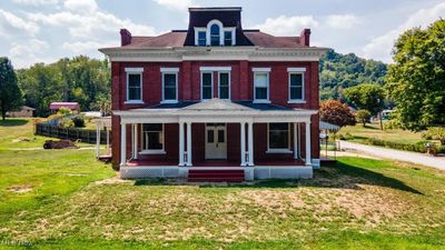 View of front of house with a front yard and covered porch | Image 1