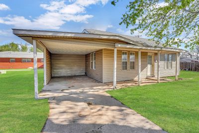 View of front of house with a carport and a front lawn | Image 2