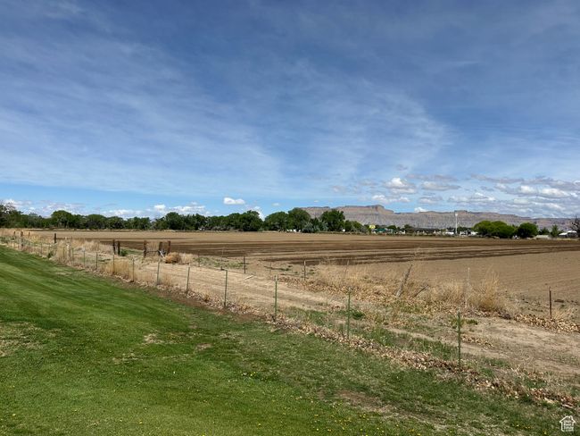 View of yard featuring fence, a rural view, and a mountain view | Image 20