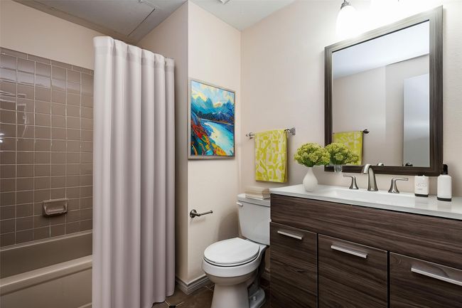 Bathroom featuring toilet, vanity, and shower / tub combo | Image 21