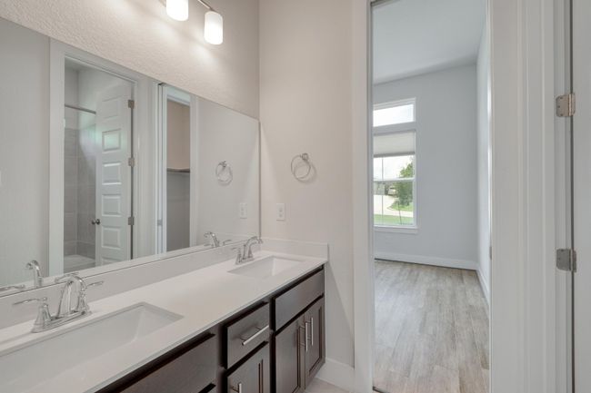 Full bath with double vanity, wood finished floors, and shower / bathtub combination | Image 25