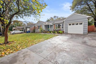 Ranch-style house with a garage and a front yard | Image 2