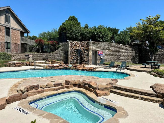 Community pool featuring a patio area and a hot tub | Image 28