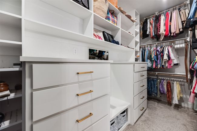 Spacious closet featuring light colored carpet | Image 28