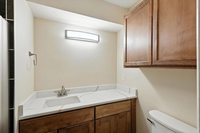 Bathroom featuring toilet and vanity | Image 13
