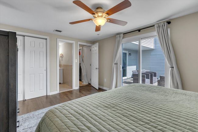 Bedroom featuring visible vents, ceiling fan, baseboards, wood finished floors, and access to outside | Image 6