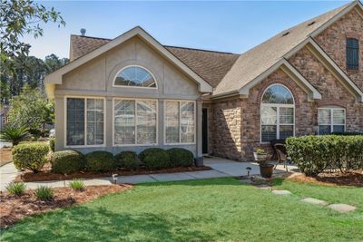 View of front of home featuring a front lawn and a patio area | Image 1