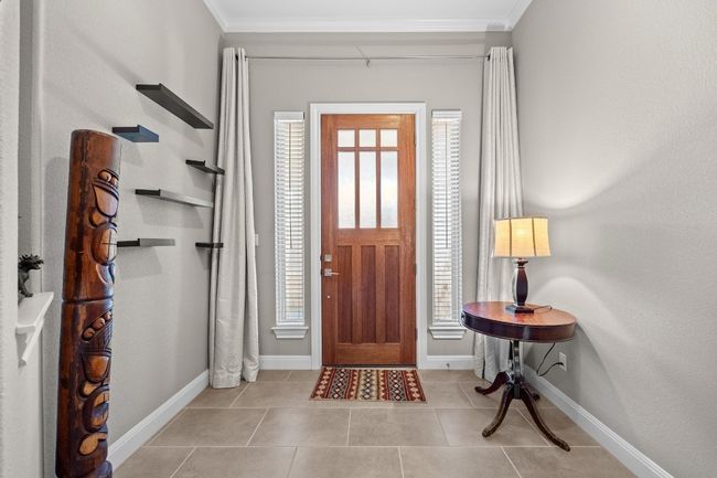 As soon as you step inside, high ceilings and natural light pull you in, this entry makes a lasting first impression | Image 6