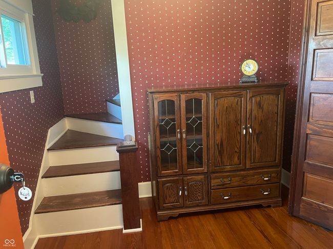stairway with wallpapered walls and wood finished floors | Image 10