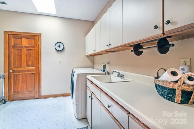 Laundry room provides access to the room that can be used as an office or storage area. | Image 23