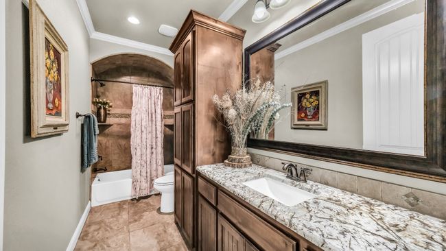 Full bathroom with vanity, crown molding, and shower / bath combo with shower curtain | Image 8