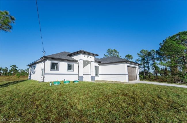 View of front of house with a garage and a front lawn | Image 23