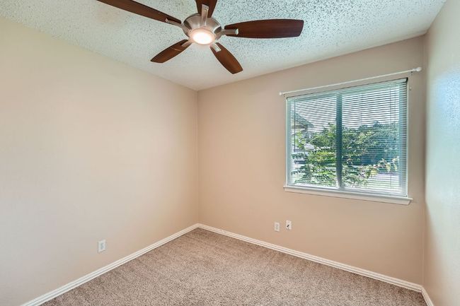 Bedroom #2 offers great natural light and a ceiling fan with remote control. | Image 9