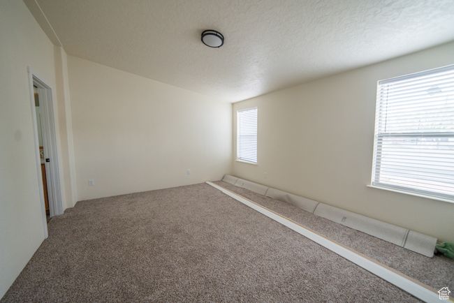 Carpeted spare room with plenty of natural light | Image 16