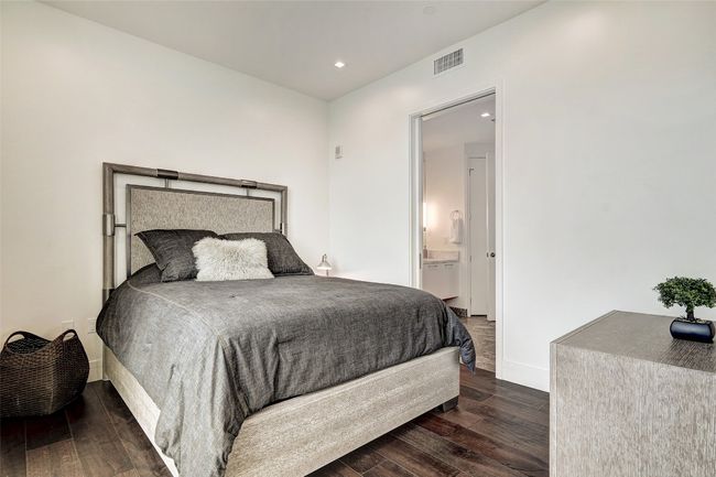Bedroom with dark wood-type flooring, recessed lighting, and connected bathroom | Image 22