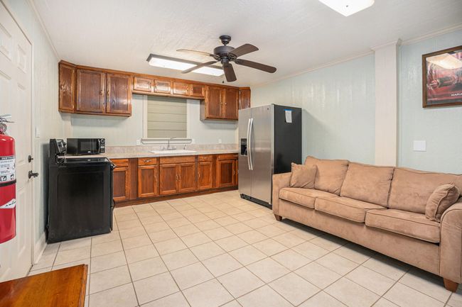 The first floor features a valuable secondary living space, boasting its own kitchen, a full bathroom, and a closet for added convenience. | Image 38