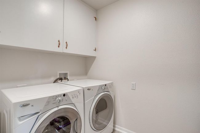 Washroom with cabinet space and washing machine and dryer | Image 32