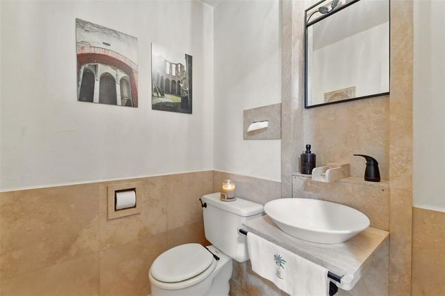 The current owners designed and crafted this one of a kind half bathroom sink with Cordova Shell Stone. | Image 13