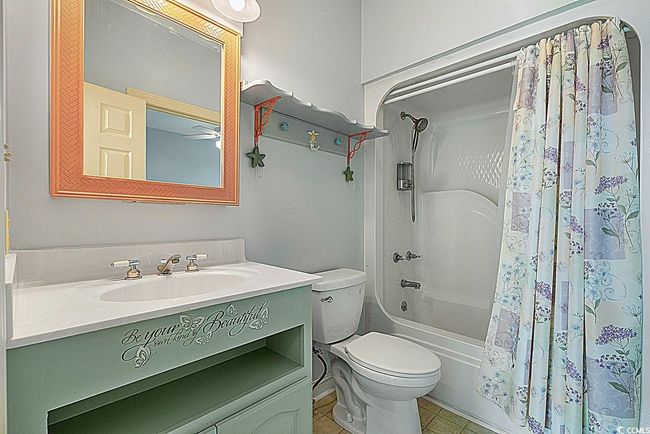 Bathroom featuring shower / bath combo, vanity, toilet, and tile patterned floors | Image 16