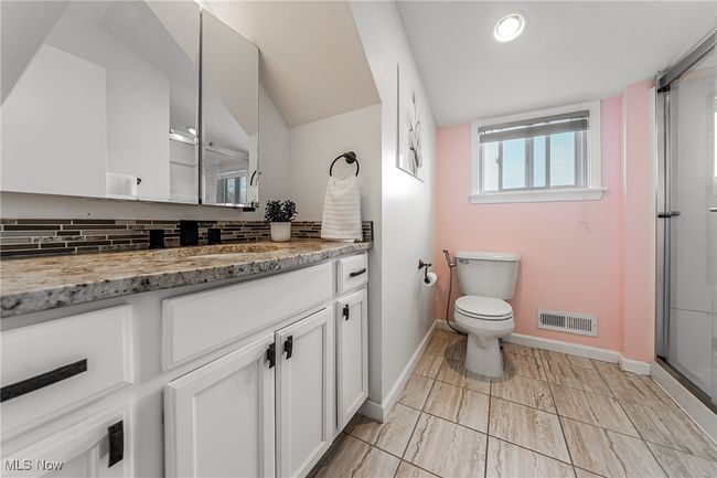 Bathroom featuring visible vents, baseboards, toilet, vanity, and tasteful backsplash | Image 28