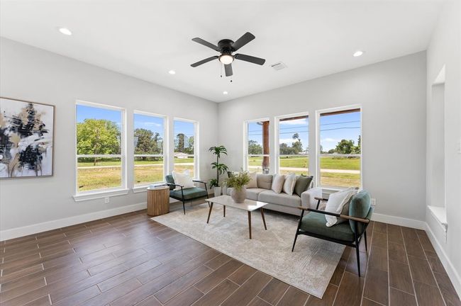 Airy open living room with large windows. | Image 8