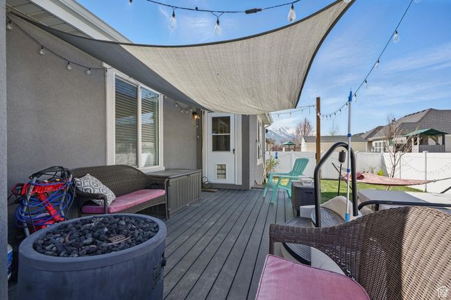 Wooden deck with a fenced backyard | Image 52