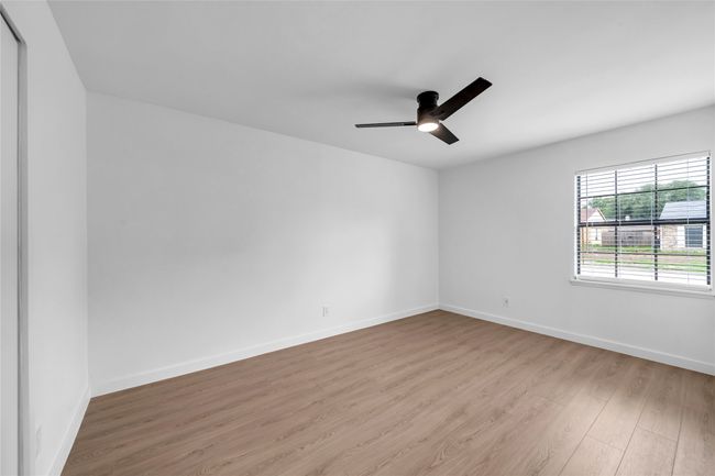 Unfurnished room featuring wood finished floors, ceiling fan, and baseboards | Image 21