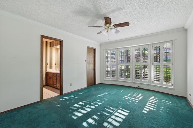 Carpeted spare room featuring ornamental molding, a wealth of natural light, and a ceiling fan | Image 33