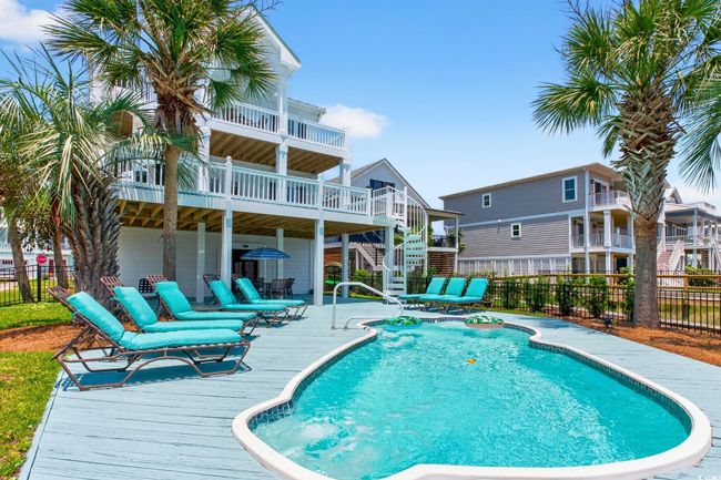 View of swimming pool featuring stairway, a wooden deck, and a patio | Image 36