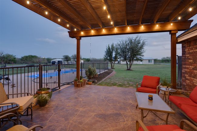 View of patio / terrace featuring a pergola, a fenced in pool, and fence | Image 31
