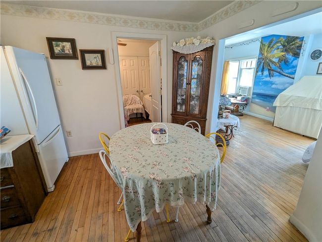 Dining room featuring hardwood / wood-style floors and baseboards | Image 21