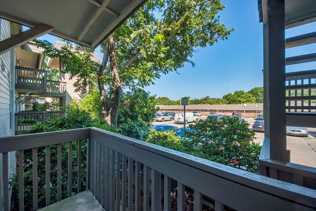 View from the balcony highlighting the surrounding greenery and the open sky. | Image 25