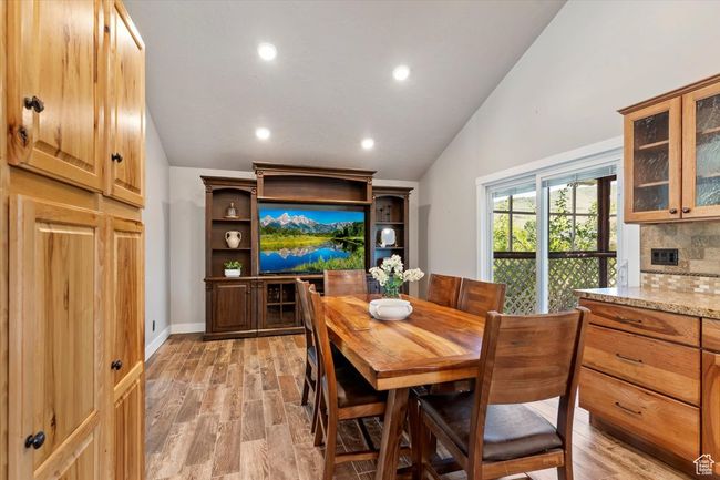 Dining area with lofted ceiling, light wood-style floors, and recessed lighting | Image 6