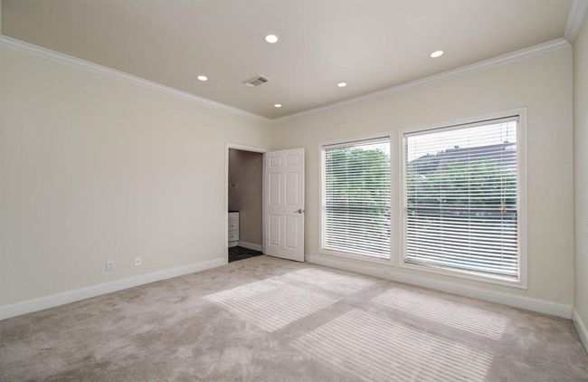 Bright and inviting second bedroom with large windows offering plenty of natural light. | Image 15