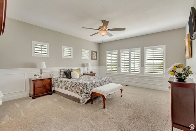 Bedroom with a wainscoted wall, carpet floors, and multiple windows | Image 14