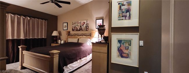 Bedroom with lofted ceiling, carpet floors, and ceiling fan | Image 11