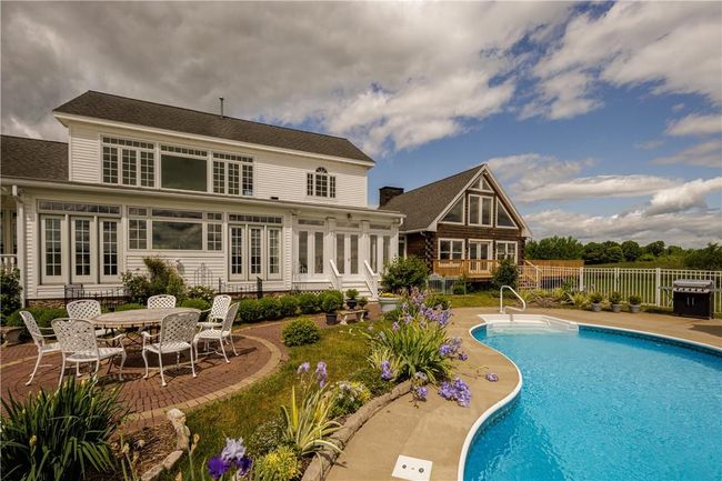 View of swimming pool with a patio | Image 26