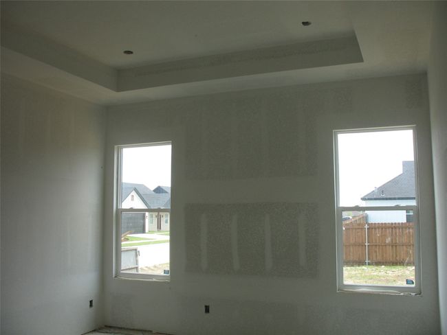 Empty room featuring a tray ceiling | Image 13