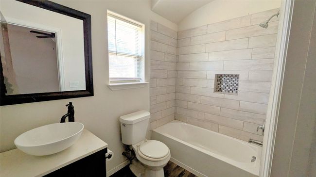 Bathroom featuring shower / bathtub combination, toilet, wood finished floors, and vanity | Image 11
