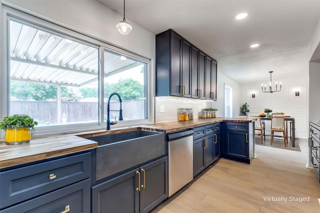 Kitchen featuring dishwasher, wooden counters, healthy amount of natural light, and recessed lighting | Image 11