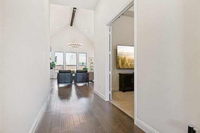 Corridor with a chandelier, beamed ceiling, high vaulted ceiling, and dark wood finished floors | Image 7
