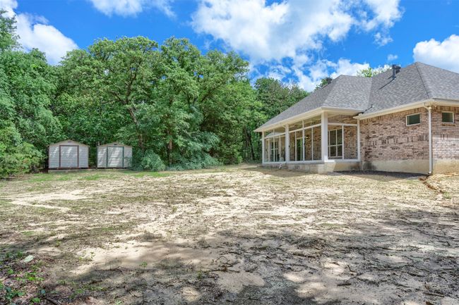 View of yard featuring a storage unit, an outbuilding, and a sunroom | Image 31