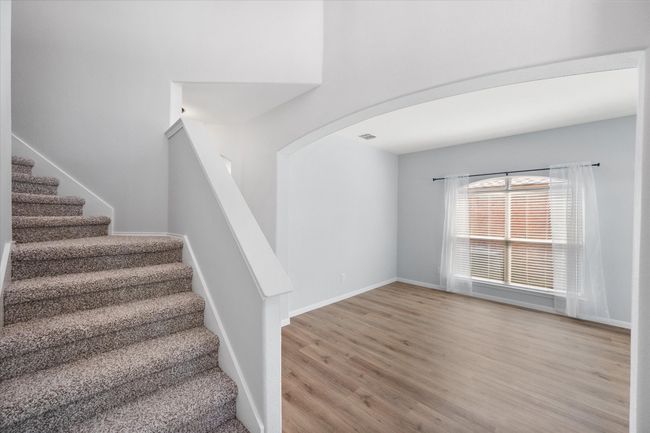 Stairway featuring arched walkways and NEW laminate floors | Image 5