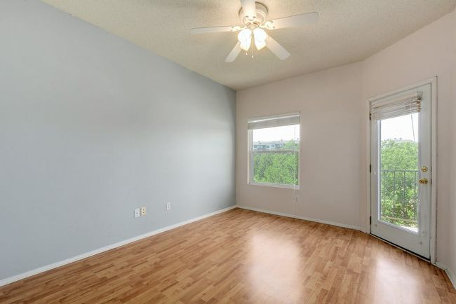 Primary bedroom with views of the greenbelt and private dooor to the balcony. | Image 12