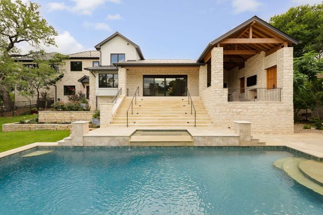 Back of property with stairway, a standing seam roof, a metal roof, and an outdoor pool | Image 28